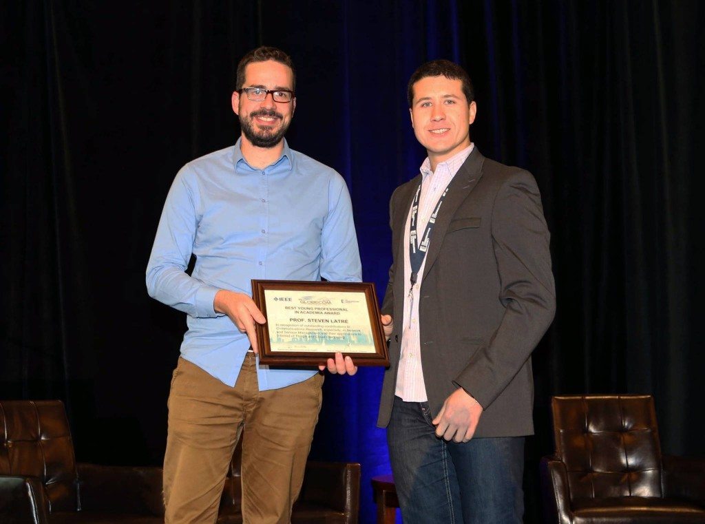 Prof. Steven Latre receiving the IEEE Young Professional Award from Mario Milicevic, Chair of the Young Professionals.
