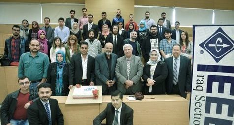Group photo of IEEE Young Professionals at section meeting with large banner